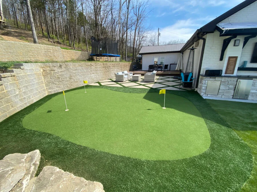 Cleaned synthetic turf back yard with putting green